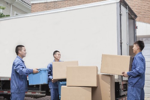 Professional movers loading furniture for a Todenmark home relocation