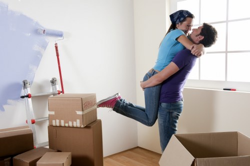 Professional movers handling furniture and boxes in a Todenmark home