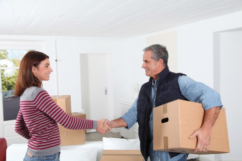 Local movers handling desks and office equipment during a Todenmark office move