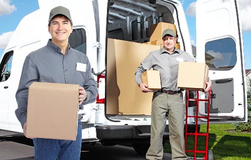 Licensed removal crew handling furniture carefully